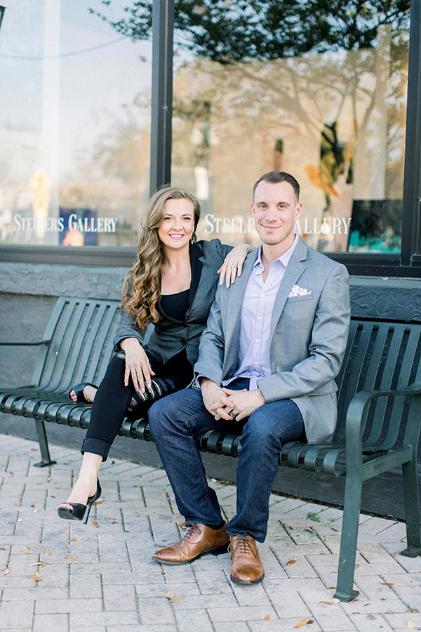 man and woman sitting on bench